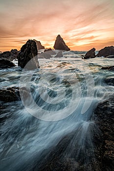 Evening Sunset at a Tropical Rocky Beach