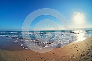 Evening surf and sunset at sandy beach