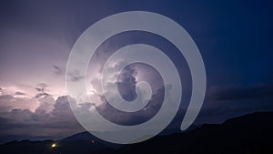 Evening thunderstorm with lightning in the mountains. Dramatic clouds during a thunderstorm pierce the light of