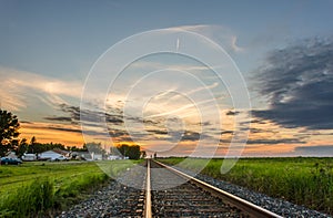 Evening in the town near the railroad tracks, retiring into the photo