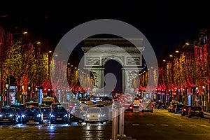 Evening traffic on Champs-Elysees in front of Arc de Triomphe Paris, France at Christmas Time