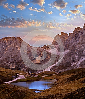 Evening twilight autumn alpine Dolomites mountain scene, Trento, Italy. Lake or Laghetto Baita Segantini view