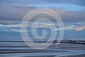 Evening view of Blackrock Beach during low tide with Dun Laoghaire harbor seen in background, Dublin Ireland