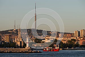 Evening view from the Bosphorus on Uskudar district, lighthouse and the CamlÃÂ±ca TRT Television Tower in the background. photo
