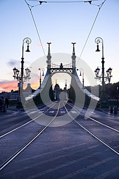 Evening view of Budapest's iconic green iron bridge. Night lights, Danube River, cityscape