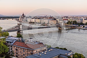 Evening view of Danube river with Szechenyi Lanchid bridge and Hungarian Parliament Building in Budapest, Hunga