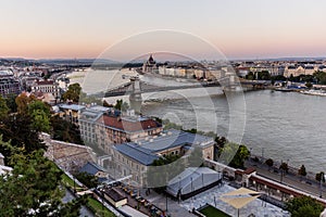 Evening view of Danube river with Szechenyi Lanchid bridge and Hungarian Parliament Building in Budapest, Hunga