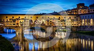 Evening view of the famous bridge Ponte Vecchio on the river Arno in Florence, Italy. The  Ponte Vechio bridge is one of the main