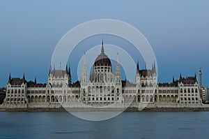 Evening view of the illuminated building of the Hungarian Parliament in Budapest.