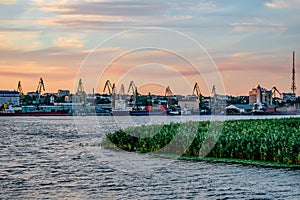 Evening view of the Kherson port from the Dnieper river Ukraine. Islet of reeds in the water against the background of the