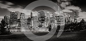 Evening view of Lower Manhattan skyscrapers across Brooklyn Bridge Park in Black & White