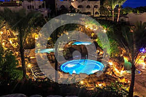 Evening view for luxury swimming pools in night illumination