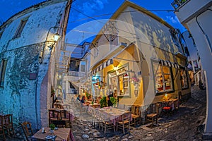 Evening view of the narrow streets, traditional taverns, Greek Mediterranean architecture, Skiathos old town, Greece