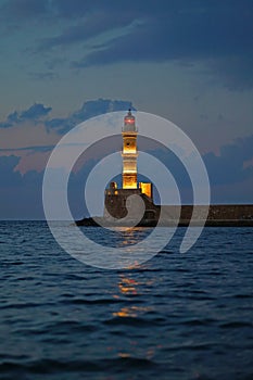 Evening view after sunset of the lighthouse at the entrance of the port of Xania photo