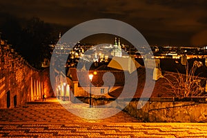 Evening walk in empty city of Prague,Czech Republic.Illuminated Old Stairs from Prague Castle to Lesser Town.Night city lights.