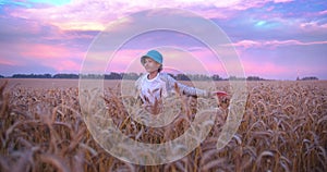 Evening Wanderlust: Young Boy Exploring Wheat Field Under Vibrant Sky