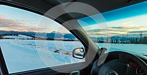 Evening winter mountain ridge view thru car windshield