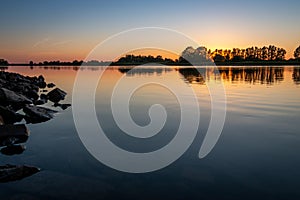 In the evenings with a beautiful sunset at the river `de IJssel`