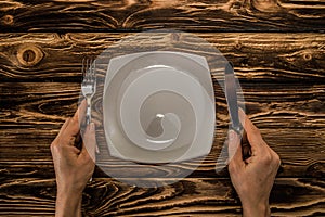 evenly folded cutlery on a wooden table