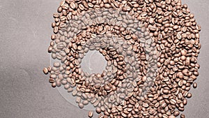 Evenly scattered coffee beans on a black background.
