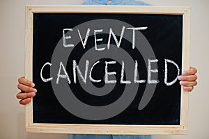 Event cancelled. Coronavirus concept. Boy hold inscription on the board