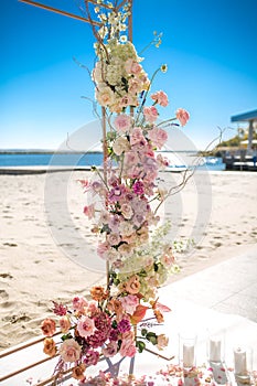 Event decoration. Wedding chuppa at riverside decorated with fresh flowers. Florist workflow