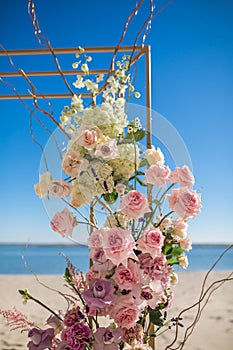 Event decoration. Wedding chuppa at riverside decorated with fresh flowers. Florist workflow