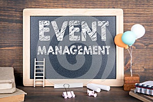 Event management. Business background. Chalkboard and wooden background