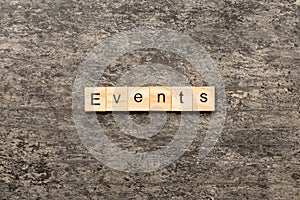 Events word written on wood block. Events text on cement table for your desing, concept