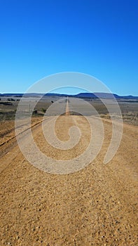 Ever ending very long dirt road in the Australian desert