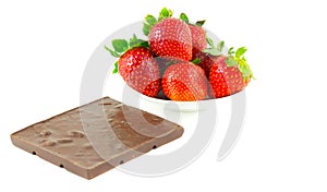 Everal strawberries on a saucer and a chocolate