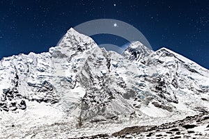 Everest mountain panoramic view on a starry night.