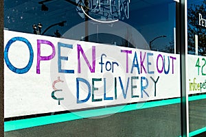 Closed Downtown Business signs advertising grab and go take out food due to state mandated