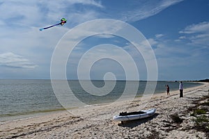 Young beach campers flying kite on Middle Cape Sable beach in Everglades.