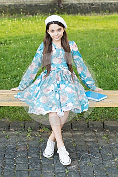 Every baby is beautiful. Beauty look of baby girl. Small baby sit on park bench. Little baby in summer style. Fashion