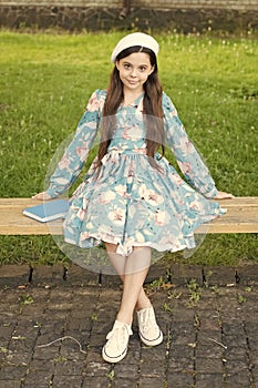 Every baby is beautiful. Beauty look of baby girl. Small baby sit on park bench. Little baby in summer style. Fashion