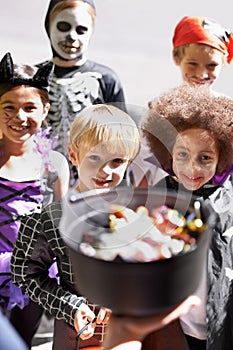 Every childs favorite holiday. Portrait of a group of little children trick-or-treating on halloween.