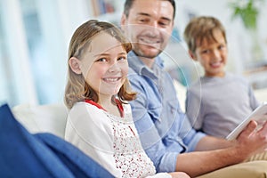 Every day with Dad is a special one. Portrait of an adorable little girl sitting next to her brother and father while