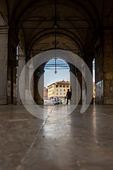 Every day life as it appears from inside the Logge di Banchi, Pisa, Tuscany, Italy photo