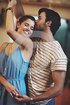 Every day is Valentines day. an affectionate young couple dancing in their kitchen at home.