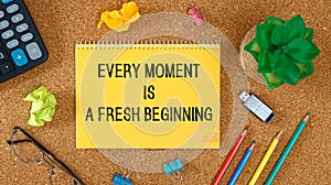 Every moment is a fresh beginning. Inspirational quotes on notebook