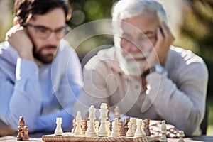 Every move has a purpose. Shot of two men playing a game of chess outside.