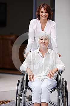 Every reason to be positive. a woman pushing her elderly mother in a wheelchair.