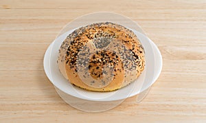 Every seasoning bagel on a white plate