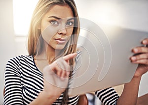Every serious business person should own a tablet. Cropped portrait of a young businesswoman working on a tablet at her