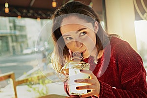 Every sip is so more-ish. a young woman enjoying a fresh beverage in a coffee shop.