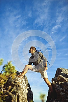 Every step takes you to the top. a young man hiking up a mountain.