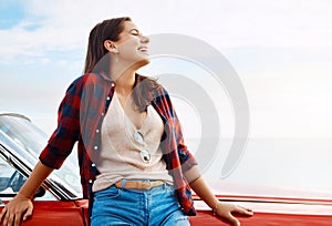 Every summer is a new adventure. a happy young woman enjoying a summers road trip.