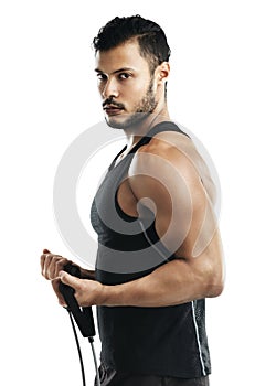 Every workout counts. Studio shot of a young man working out with a resistance band against a white background.