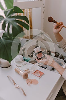 Everyday beauty routine. Make up artist. Dressing vanity. Women& x27;s hands. Pastel colors. In front of the mirror. Palettes